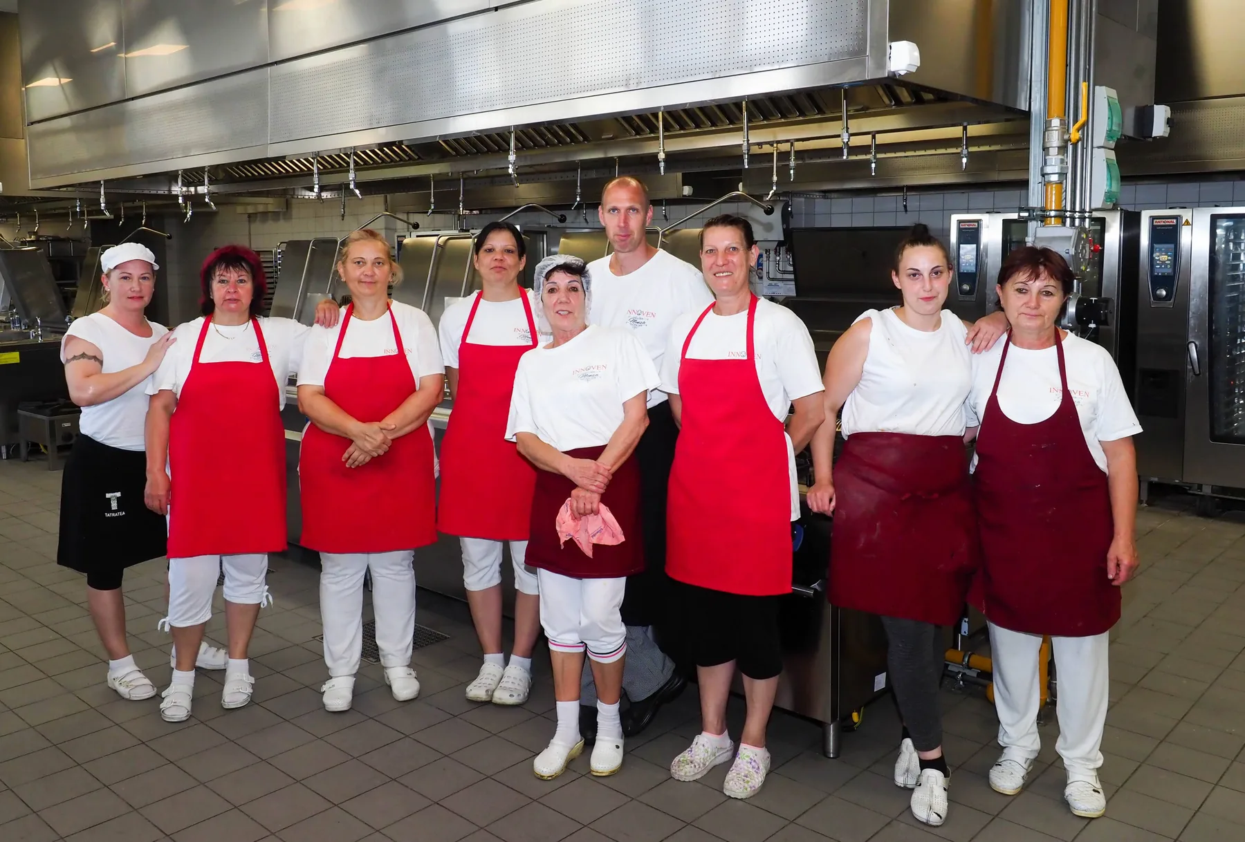 The kitchen team in aprons in the large kitchen